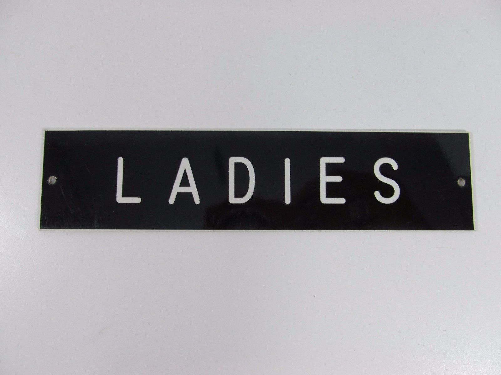 LADIES SIGN/PLAQUE WALL OR DOOR MOUNTED BLACK PLASTIC 8″ X 2″