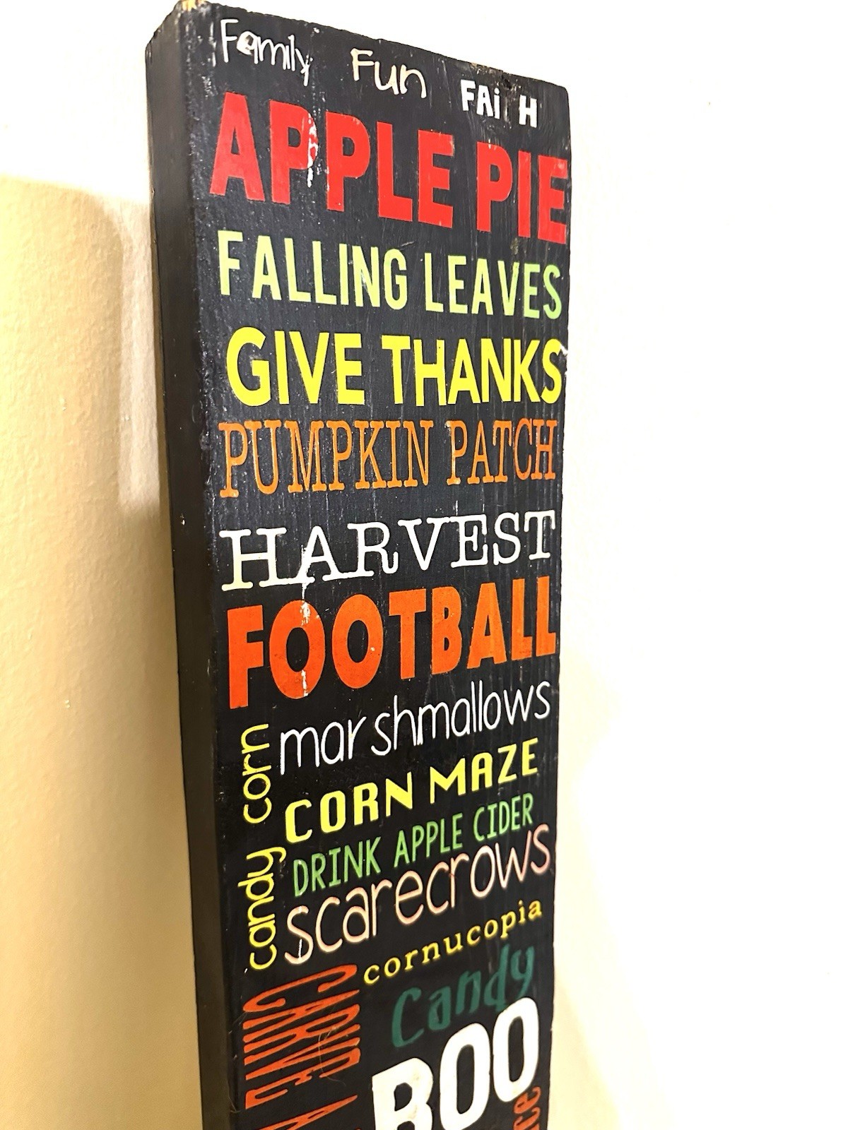 Wooden 25” porch leaner features a collage of fall activities & holidays