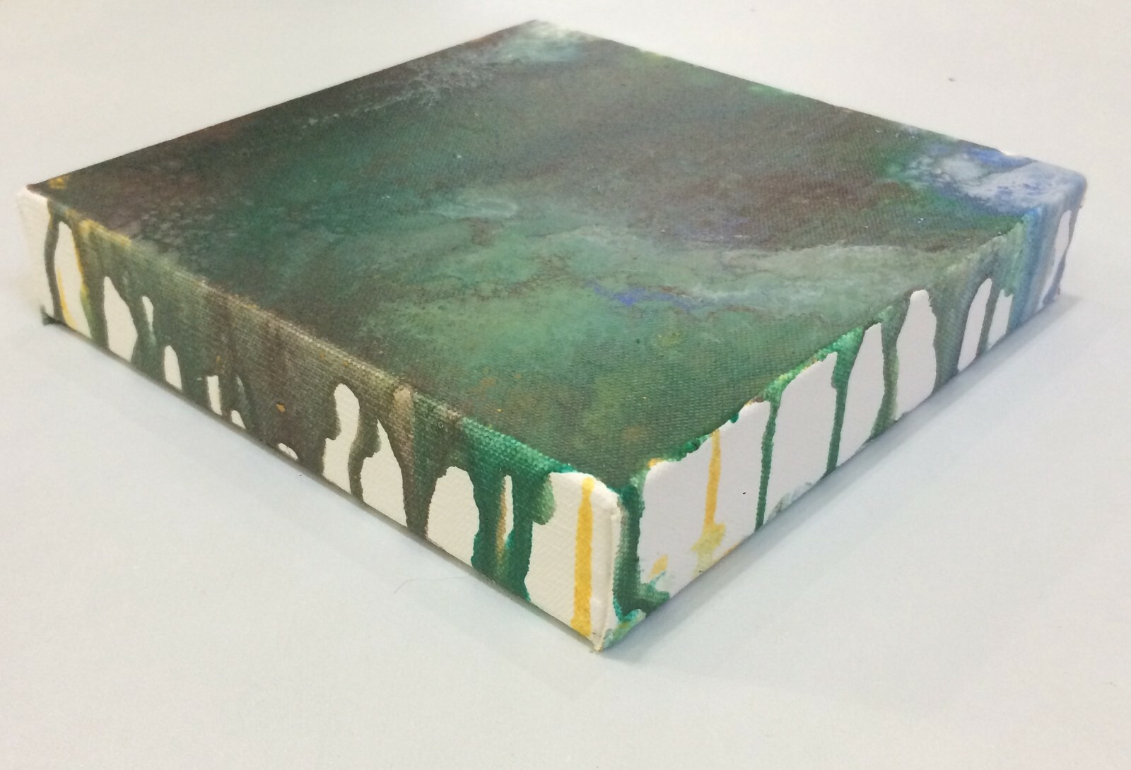 small wall art paint pour in green, blue, brown and white and yellow
